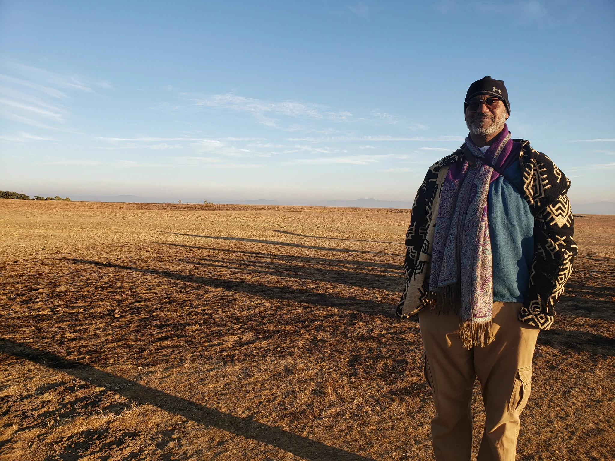 David standing in an open landscape, his full figure and the broad horizon visible.