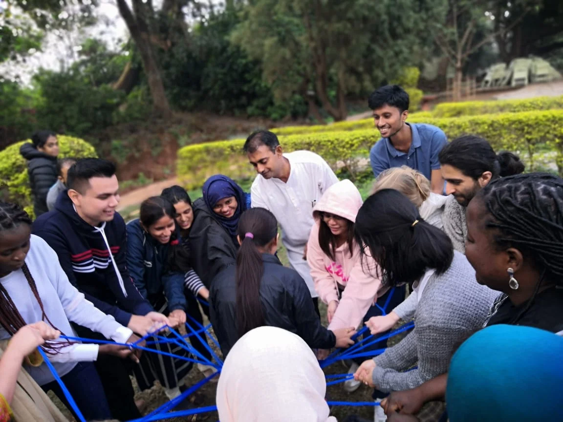People in a close outdoor circle taking part in a shared activity.