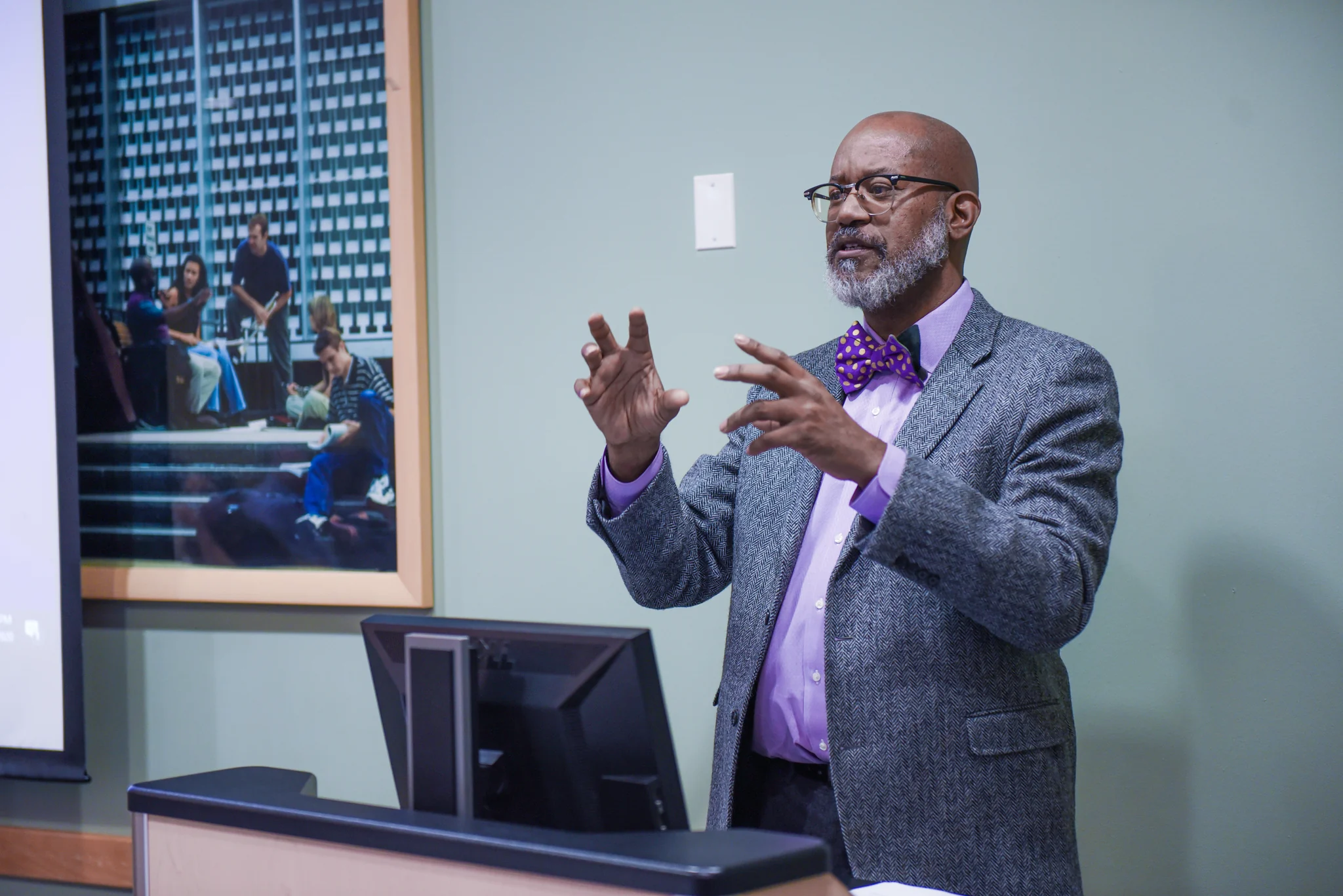 David gesturing while addressing a room during a workshop.