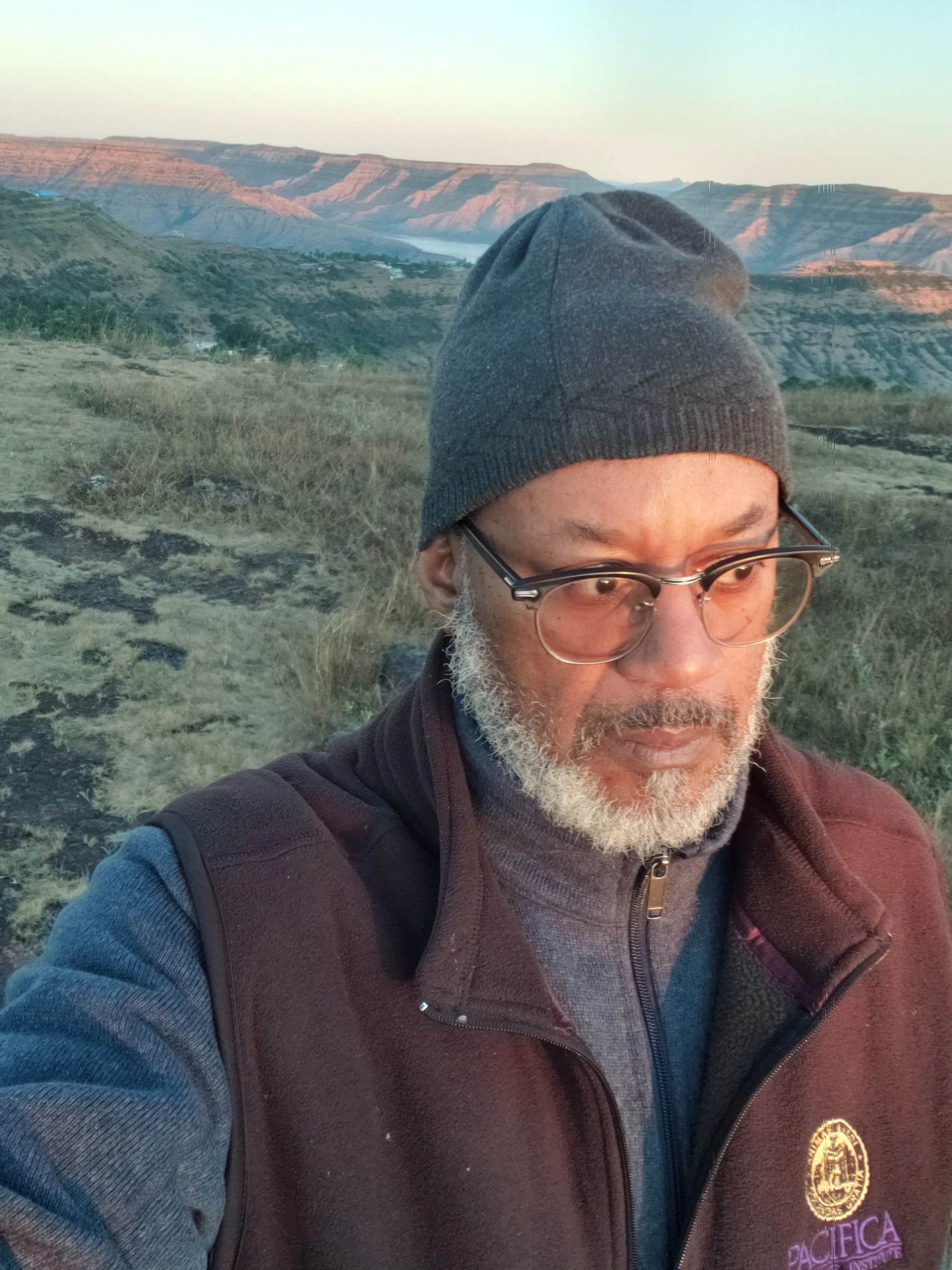 David outdoors with hills and open landscape behind him.